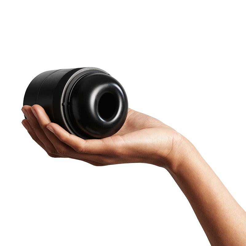 Hand holding Arcwave Voy Compact Stroker on white background