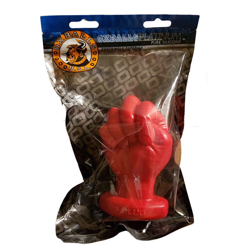 Red silicone fist anal plug in clear packaging with 'Oxballs' branding on a white background