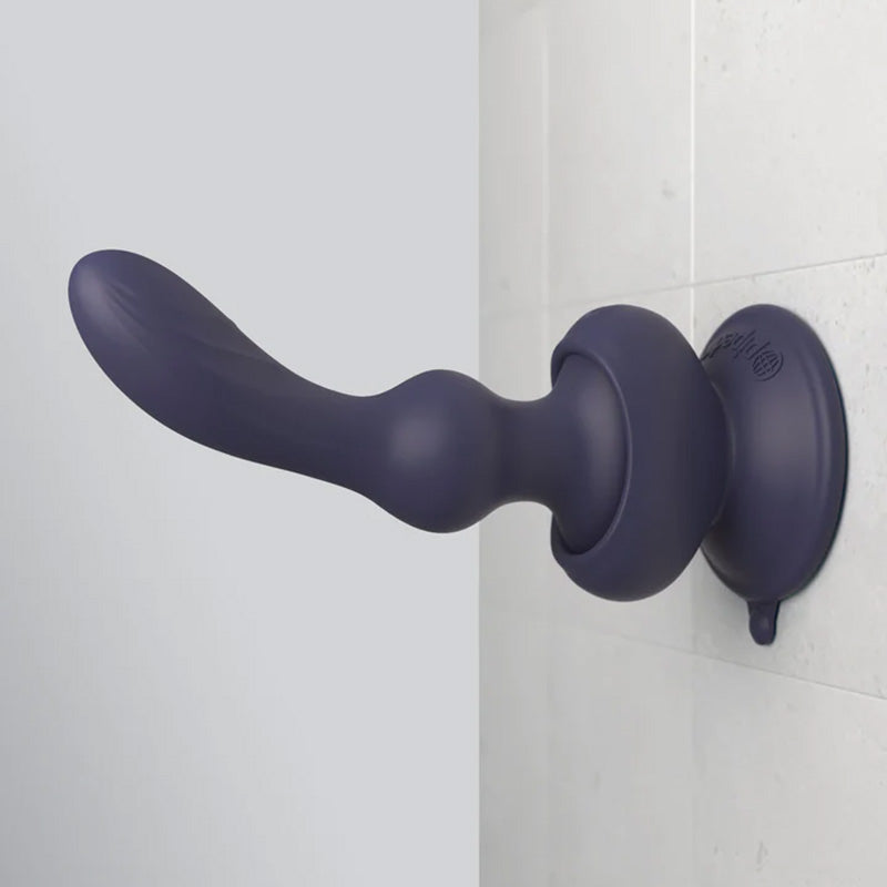 Blue silicone 3Some Wall Banger P-Spot prostate massager in its included removable suction cup base attached to a tiled wall