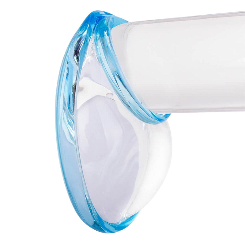 Blue cock and ball ring worn over a clear dildo on a white background